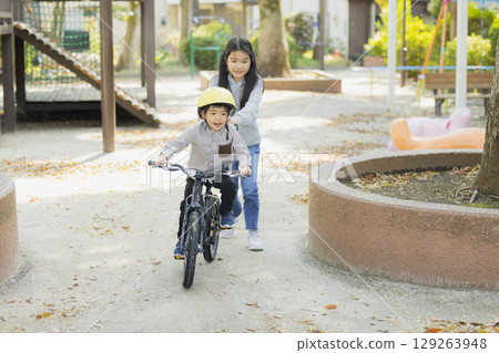 Children riding a bicycle 129263948