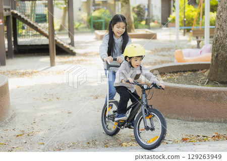 Children riding a bicycle 129263949