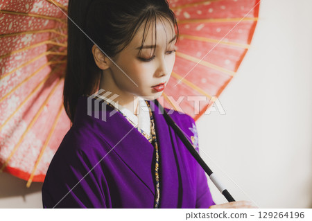 A woman in a kimono 129264196