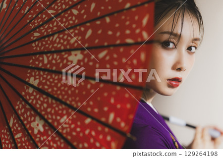A woman in a kimono A woman in a kimono 129264198