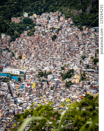 Aerial View Of Rocinha Favela In Rio De Janeiro: Dense Urban Landscape With Colorful Rooftops And Narrow Streets In The Largest Informal Settlement In Brazil Aerial View Of Rocinha Favela In Rio De Janeiro: Dense Urban Landscape With Colorful Rooftops And Narrow Streets In The Largest Informal Settlement In Brazil 129264291