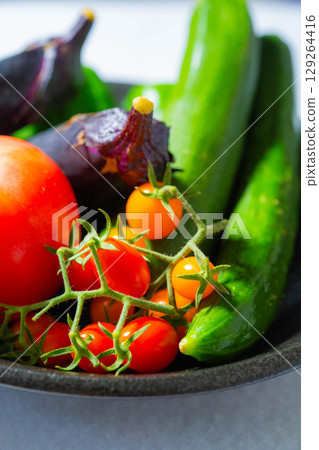 Assorted summer vegetables: tomato, eggplant, cucumber, zucchini, and bell pepper Assorted summer vegetables: tomato, eggplant, cucumber, zucchini, and bell pepper 129264416