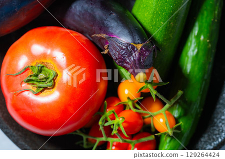 Assorted summer vegetables: tomato, eggplant, cucumber, zucchini, and bell pepper Assorted summer vegetables: tomato, eggplant, cucumber, zucchini, and bell pepper 129264424
