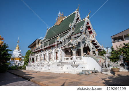 Beautiful Buddhist buildings in Wat Ming Muang an iconic temple in traditional Lanna style located in the centre of Chiang Rai town, Thailand. 129264599
