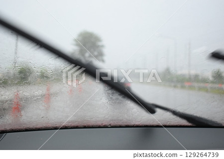 car on highway road with rainny season, blurred image 129264739