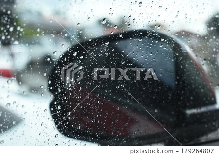 side mirror of car in rainy day, water drop on glass side mirror of car in rainy day, water drop on glass 129264807