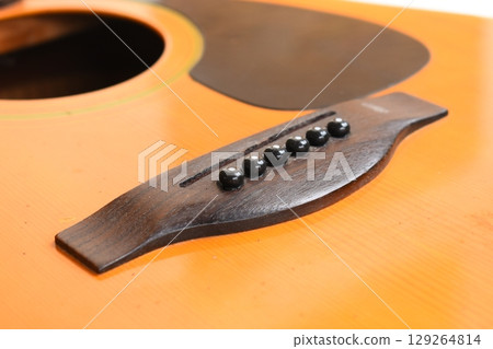 brown wood acoustic guitar isolated on white background 129264814
