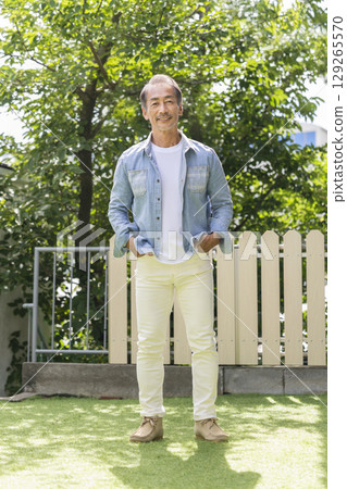 A man in his 60s smiling at the camera A man in his 60s smiling at the camera 129265570