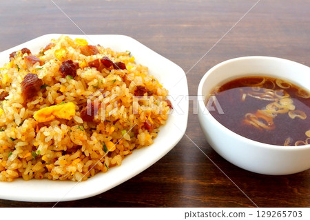 Set of fried rice and Chinese soup on table background 129265703