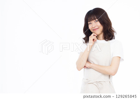 Housewife thinking with a smile Housewife thinking with a smile 129265845