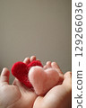 Child's hand holding a heart 129266036