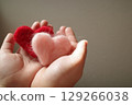 Women's hand with red heart 129266038