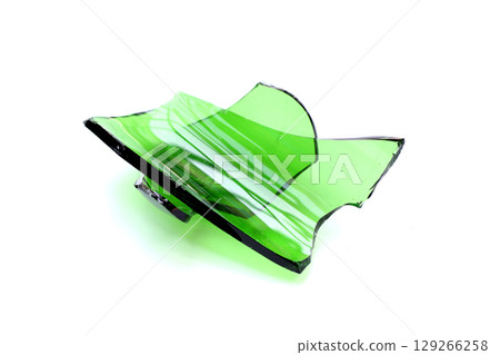 Sharp green glass shards scattered on a white background. 129266258