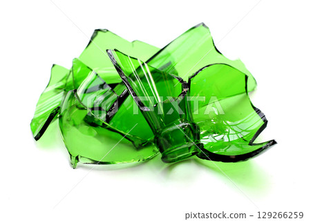Sharp green glass shards scattered on a white background. 129266259