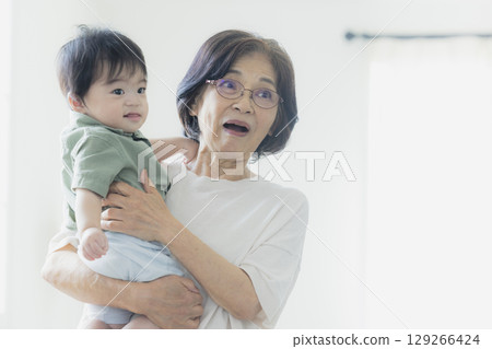Baby being held by grandma Baby being held by grandma 129266424