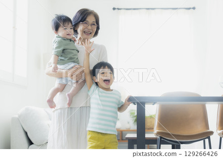 Baby being held by grandma 129266426