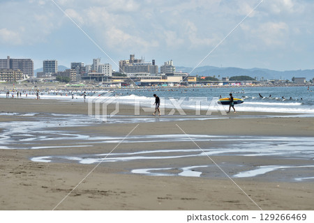 Surfers coming out of the water at Tsujido Beach 129266469