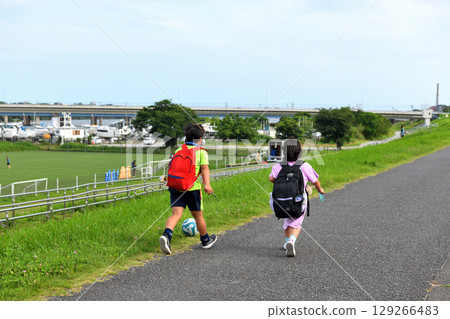 Brother and sister walking along the bank of Hiratsuka-Bairi Soccer Stadium Brother and sister walking along the bank of Hiratsuka-Bairi Soccer Stadium 129266483