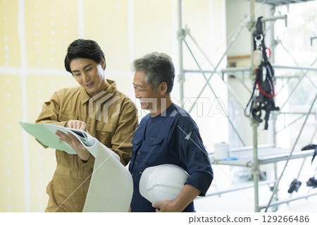 Male worker wearing a full harness Male worker wearing a full harness 129266486