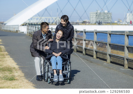 Woman in wheelchair and family 129266580