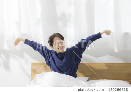 A woman stretching in bed 129266818