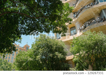 Gaudi Casa Mila Facade Architecture with Tree in Barcelona, Spain Gaudi Casa Mila Facade Architecture with Tree in Barcelona, Spain 129267331