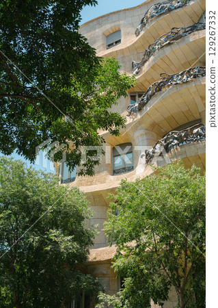 Gaudi Casa Mila Facade Architecture with Tree in Barcelona, Spain Gaudi Casa Mila Facade Architecture with Tree in Barcelona, Spain 129267332