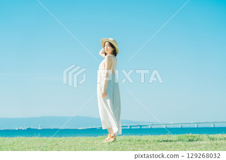 A woman in a dress enjoying vacation at a resort 129268032
