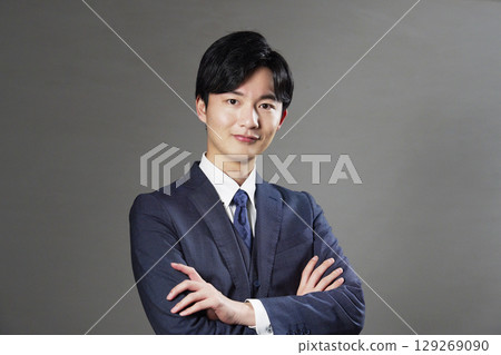 Businessman portrait black background looking at camera 129269090