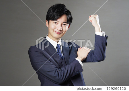 Businessman fist pump black background Businessman fist pump black background 129269120