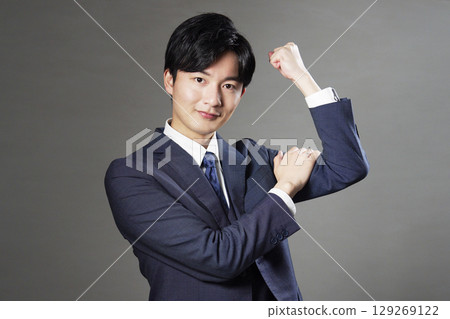 Businessman fist pump black background 129269122
