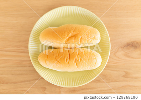 A roll of bread placed on the table 129269190