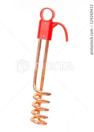 Copper immersion water heater with red plastic handle isolated on white background, used for quick water heating. 129269412