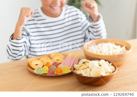 一個小學生看到所有的糖果很高興 129269740