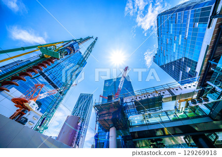 Tokyo cityscape, Japan, August 5th. Extremely hot... Huge heavy machinery such as piledrivers lined up... Towards a new chapter... = Shibuya Tokyo cityscape, Japan, August 5th. Extremely hot... Huge heavy machinery such as piledrivers lined up... Towards a new chapter... = Shibuya 129269918