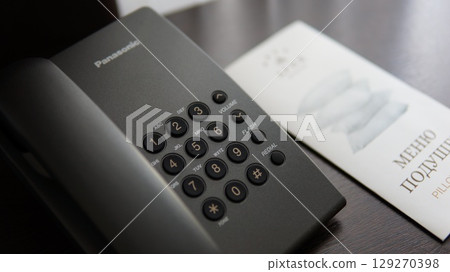 The phone is on the table in the hotel. 129270398