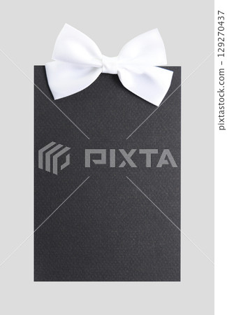 White ribbon and black paper 129270437