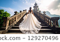 The back view of a bride walking through an old castle 129270496