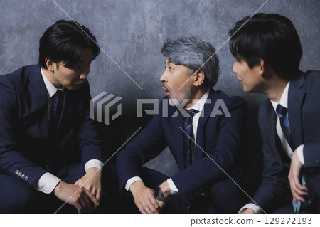 Three businessmen talking 129272193