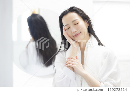 Woman looking in the mirror Woman looking in the mirror 129272214