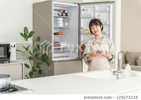 Woman opening the refrigerator, mom, housewife, housekeeper, Asian woman doing housework Woman opening the refrigerator, mom, housewife, housekeeper, Asian woman doing housework 129273238