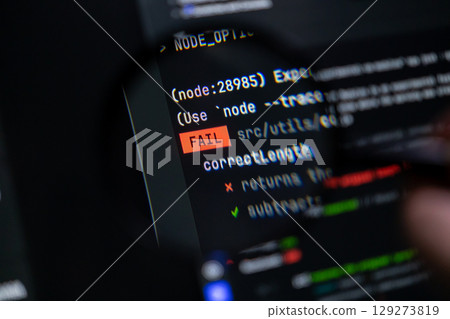 Digital programming code clearly shows a prominent FAIL message on a dark computer monitor, symbolizing debugging challenges, software development errors, and technological system failures 129273819