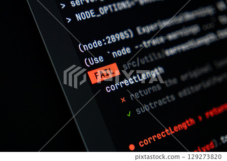 Programming code displaying a prominent red FAIL message on a dark computer screen, illustrating a critical software development error, system failure, or debugging challenge 129273820