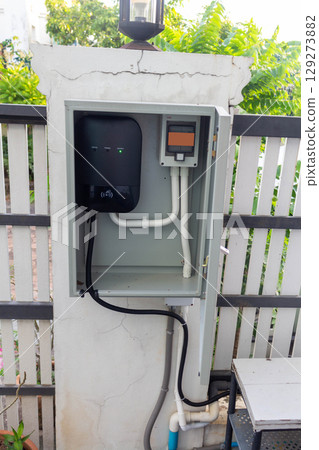 Electric Car Charger Storage Box Installed Inside the House 129273882