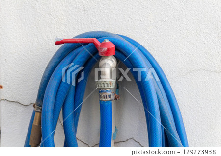 Blue Rubber Boots for Sale Beside House in the Evening Blue Rubber Boots for Sale Beside House in the Evening 129273938