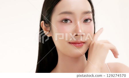 Skincare commercial of featuring a young Asian woman applying natural cosmetic cream in a soft, minimal studio setting. Ideal for promoting beauty, self-care, and organic skincare products. Skincare commercial of featuring a young Asian woman applying natural cosmetic cream in a soft, minimal studio setting. Ideal for promoting beauty, self-care, and organic skincare products. 129274570