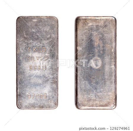 Old silver bar, tarnished and scratched, front and back side. Stamped cast silver ingot of one kilo, about 32 troy oz of metal, with a purity of 999.0, 99.9 percent pure silver, and with bar number. 129274961