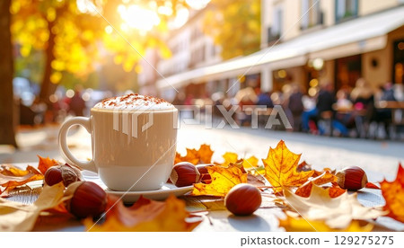 Chestnut latte on a terrace surrounded by falling leaves 129275275