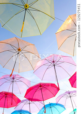A colorful umbrella sky covers the evening sky on a sunny summer day. A colorful umbrella sky covers the evening sky on a sunny summer day. 129275451