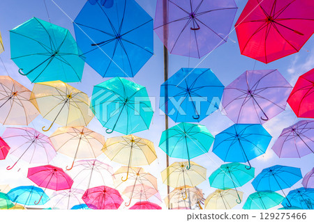A colorful umbrella sky covers the evening sky on a sunny summer day. A colorful umbrella sky covers the evening sky on a sunny summer day. 129275466